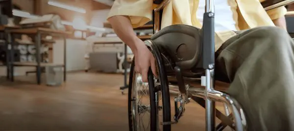 image: A man in a wheelchair navigates an office environment