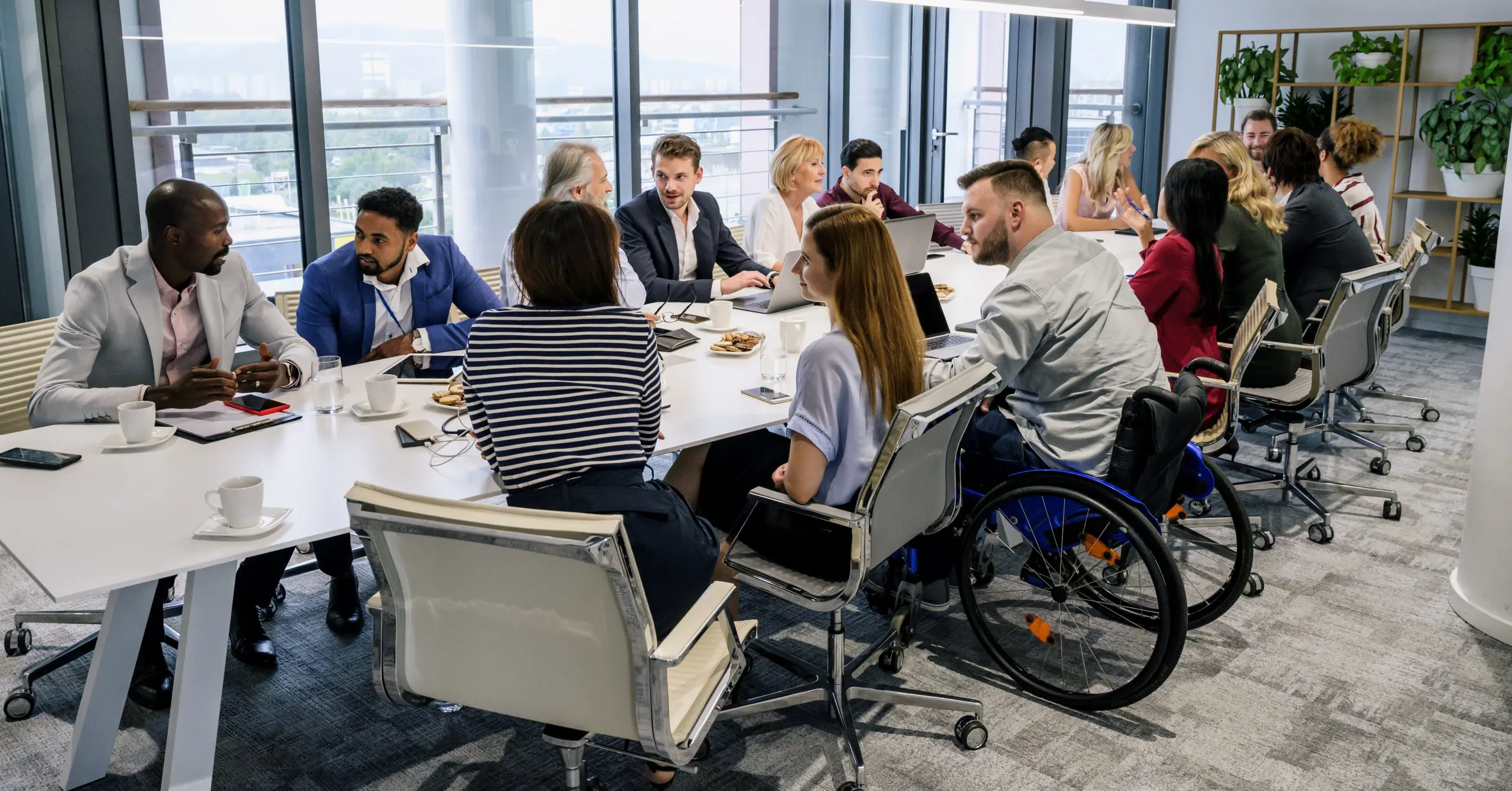 image: multiple diverse people having a meeting in an office setting
