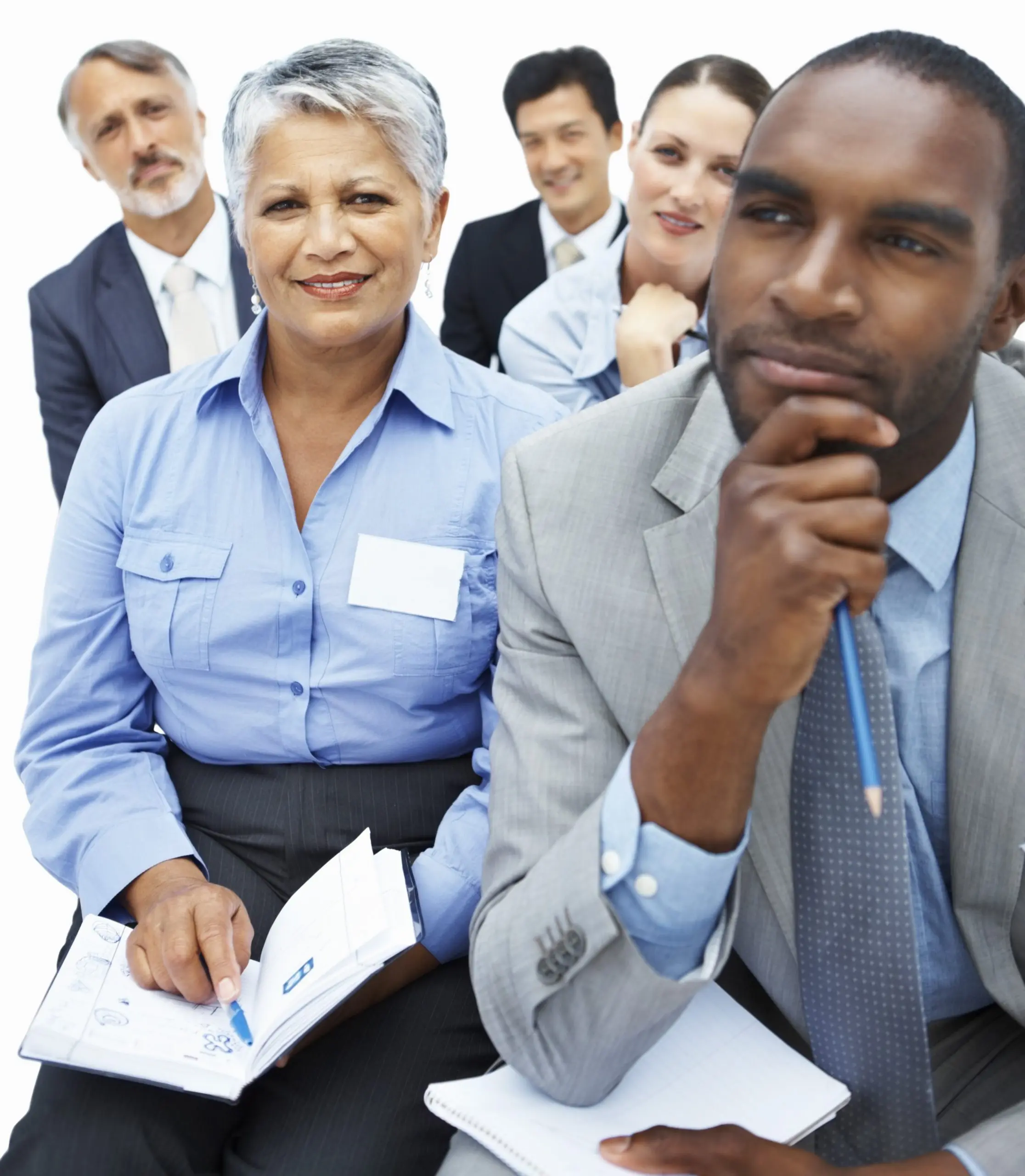 image: a group of diverse people in business attire looking paying attention during a seminar