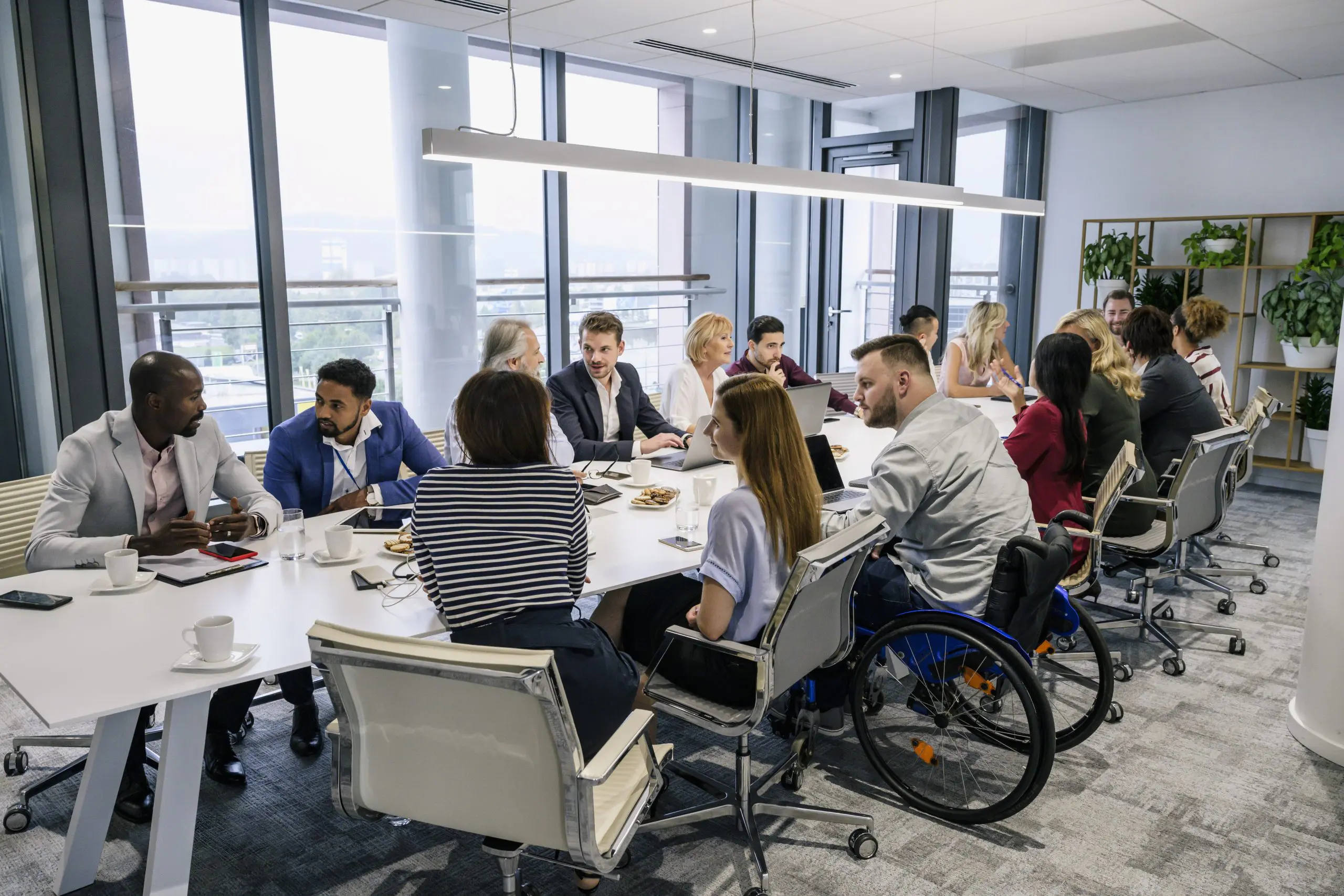 image of multiple diverse people in an office setting having a meeting