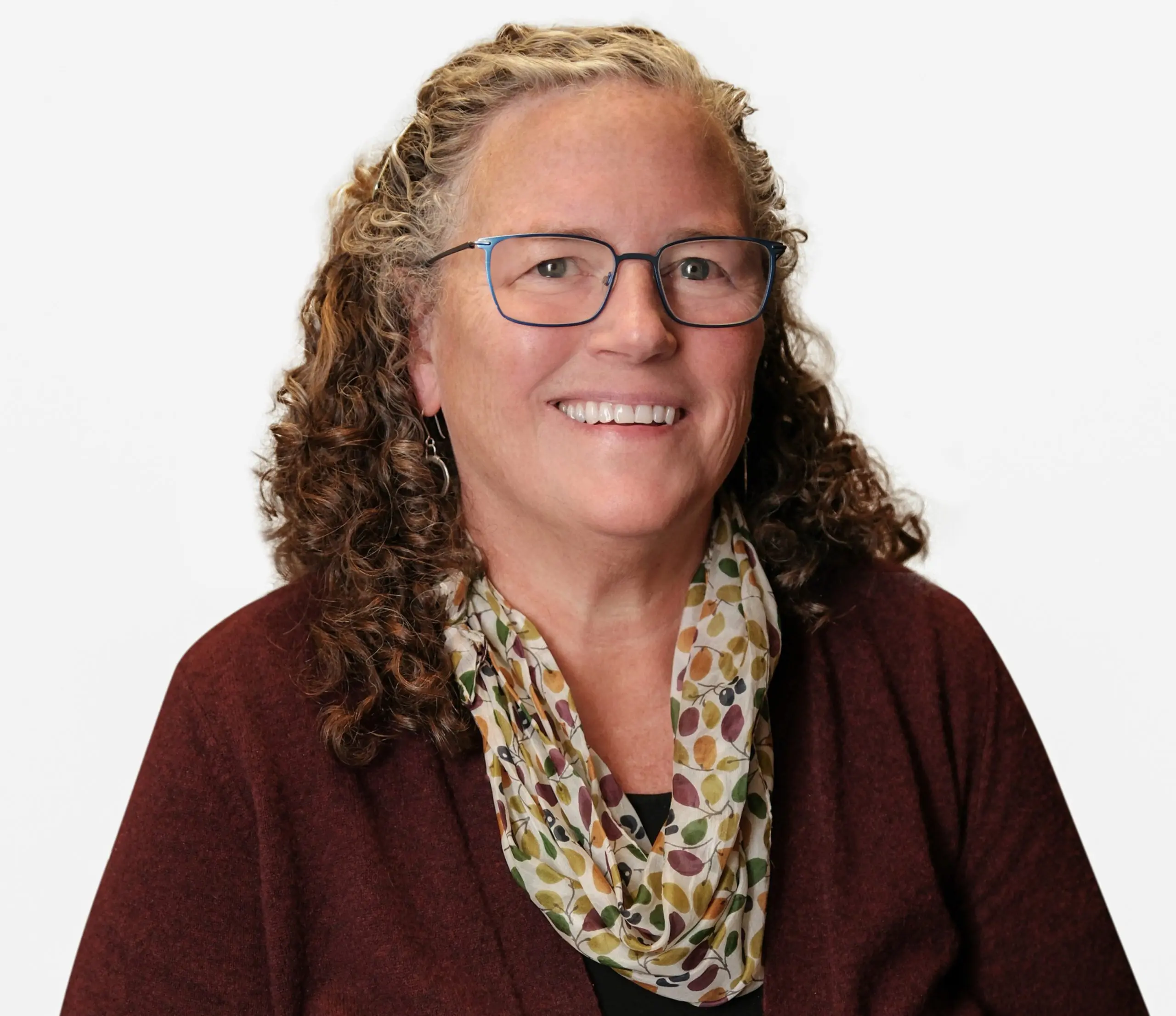 woman with glasses smiling at camera